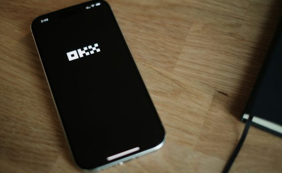 A cell phone sitting on top of a wooden table