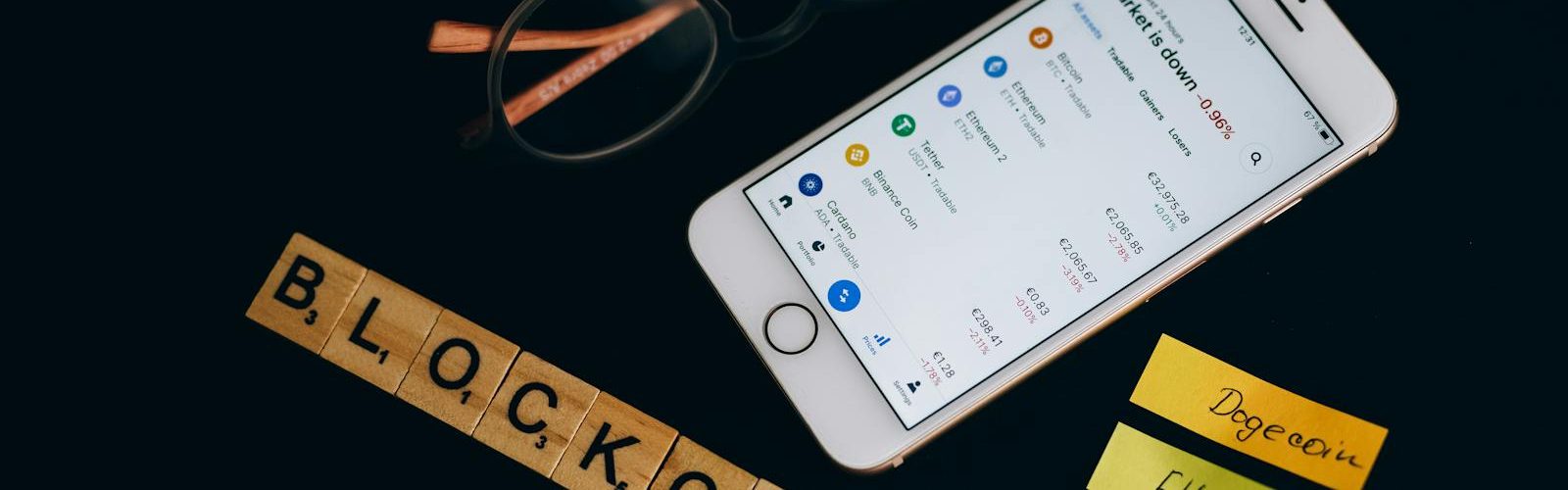 Smartphone displaying cryptocurrency market data alongside blockchain concept elements.
