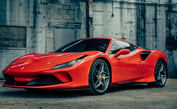 red ferrari 458 italia parked near gray building