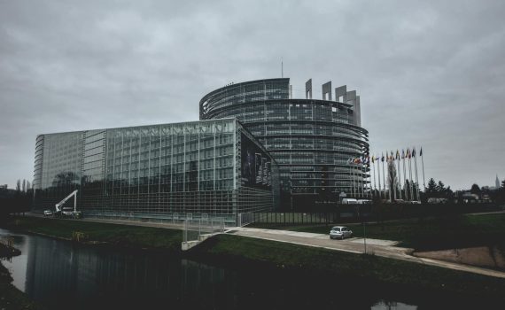 Modern architecture of the European Parliament in Strasbourg on a cloudy day.