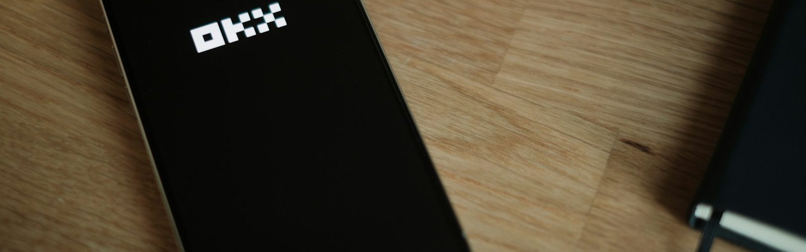 A cell phone sitting on top of a wooden table