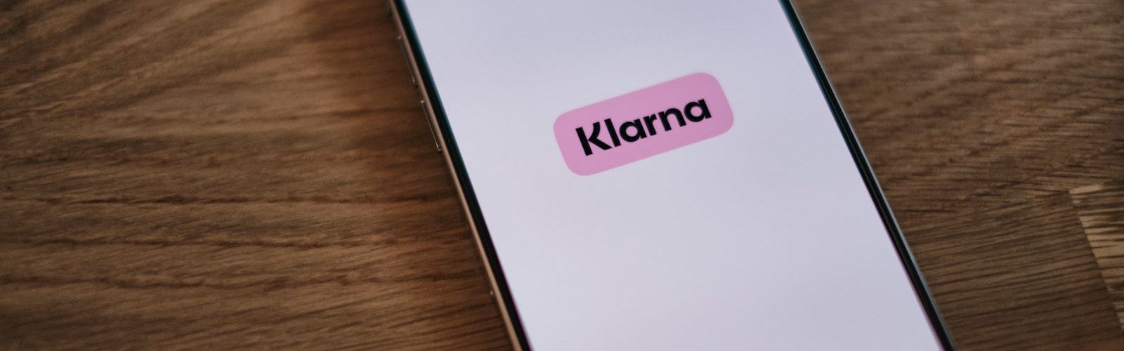 A cell phone with a pink sticker on it