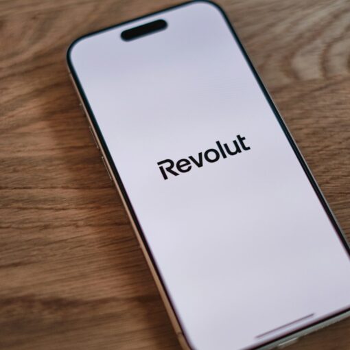 A cell phone sitting on top of a wooden table