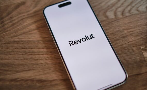 A cell phone sitting on top of a wooden table
