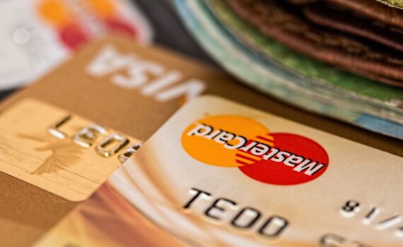 Macro shot of credit cards showing Visa and Mastercard logos next to a wallet, ideal for finance themes.