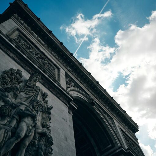 a stone building with a statue in front of it